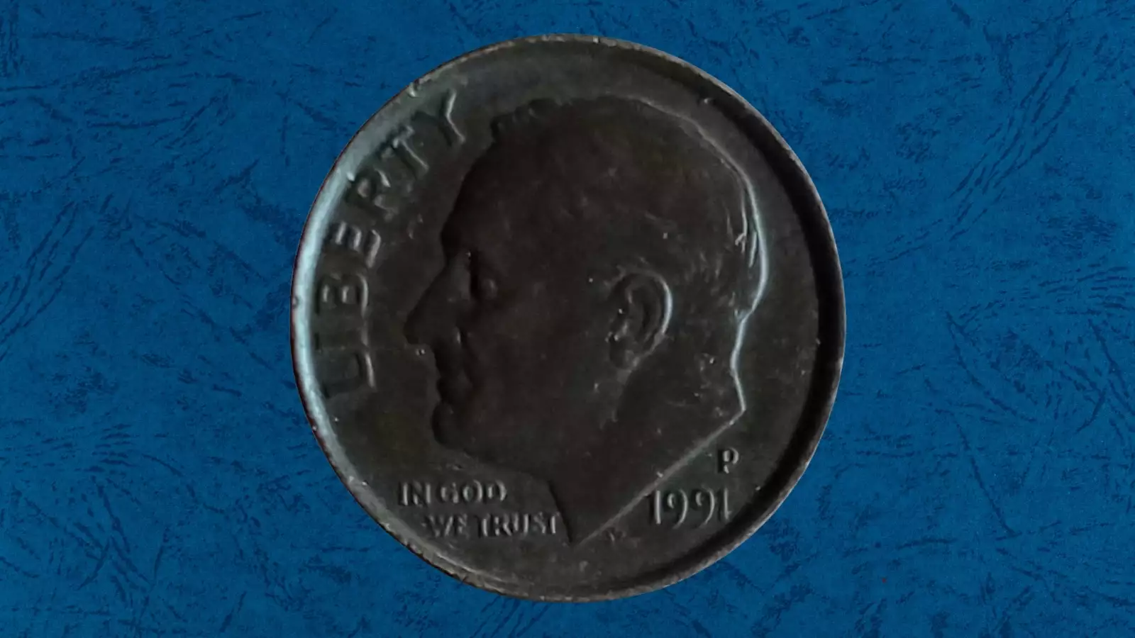1991 Roosevelt dime missing clad layer error showing copper-red reverse contrasting with normal silver-gray obverse