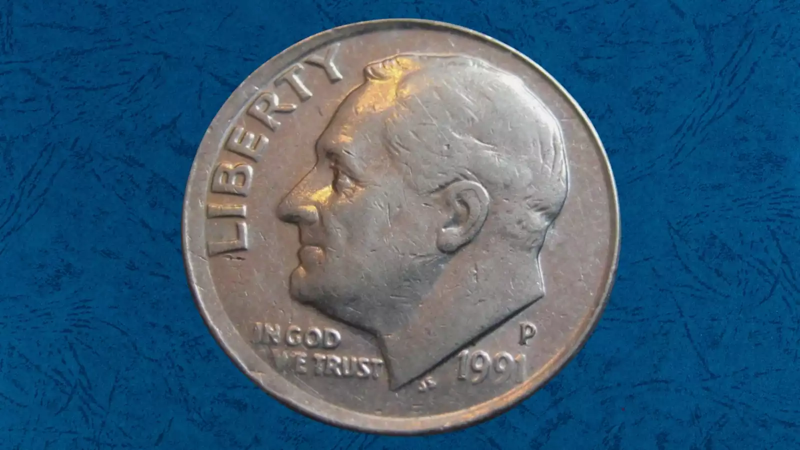1991 Roosevelt dime broadstrike error with missing collar restraint, showing wider than normal diameter and flat rim